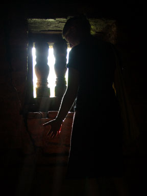 Molly standing in front of a window in the My Son ruins
